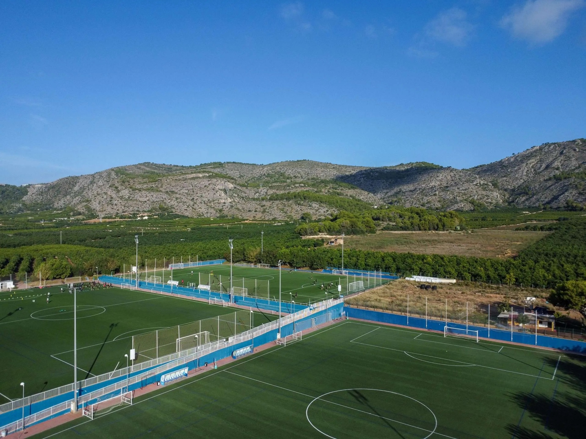 An aerial view of the Ciudad Deportiva FACSA pitches below the hills