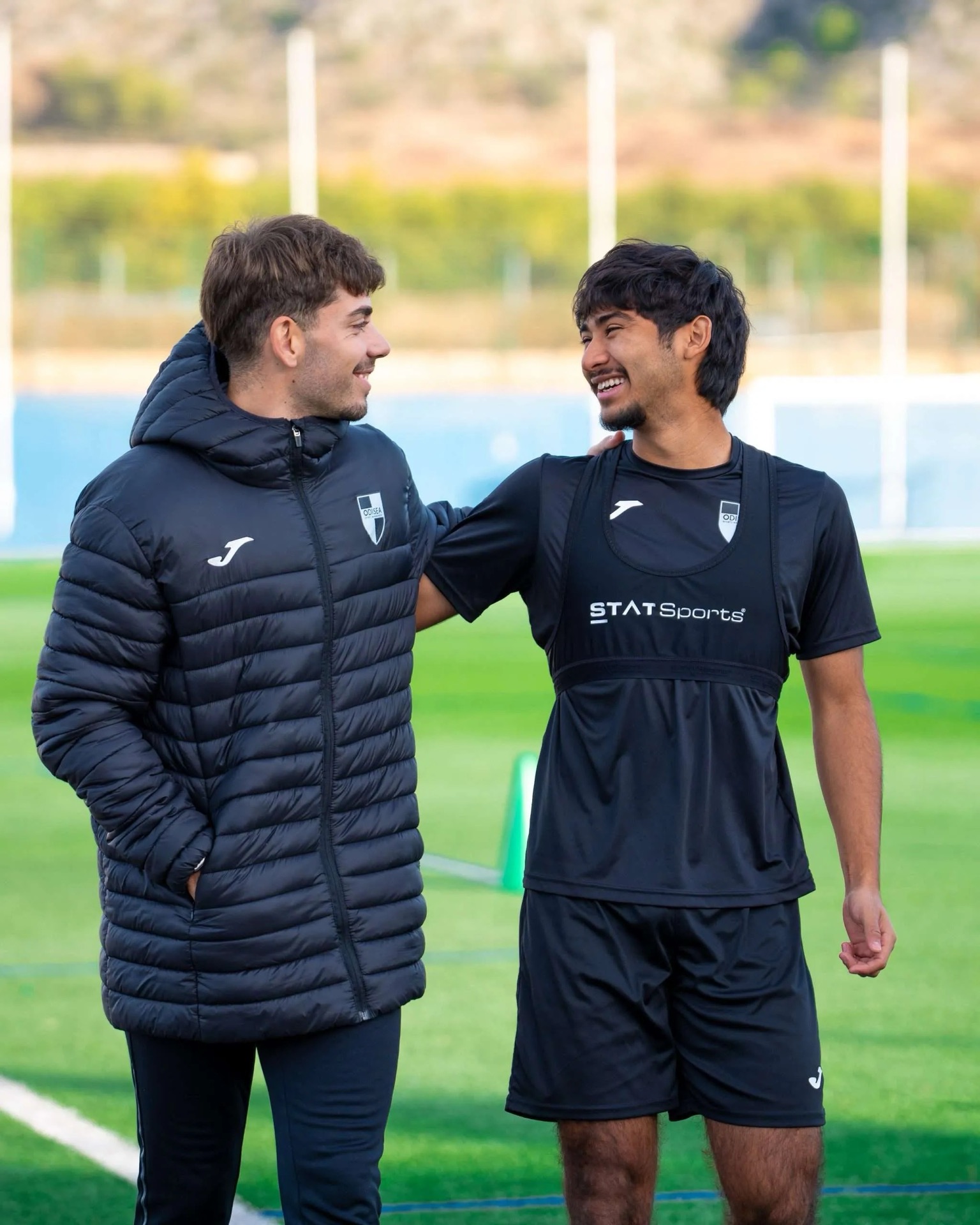 A coach and a player talking at training