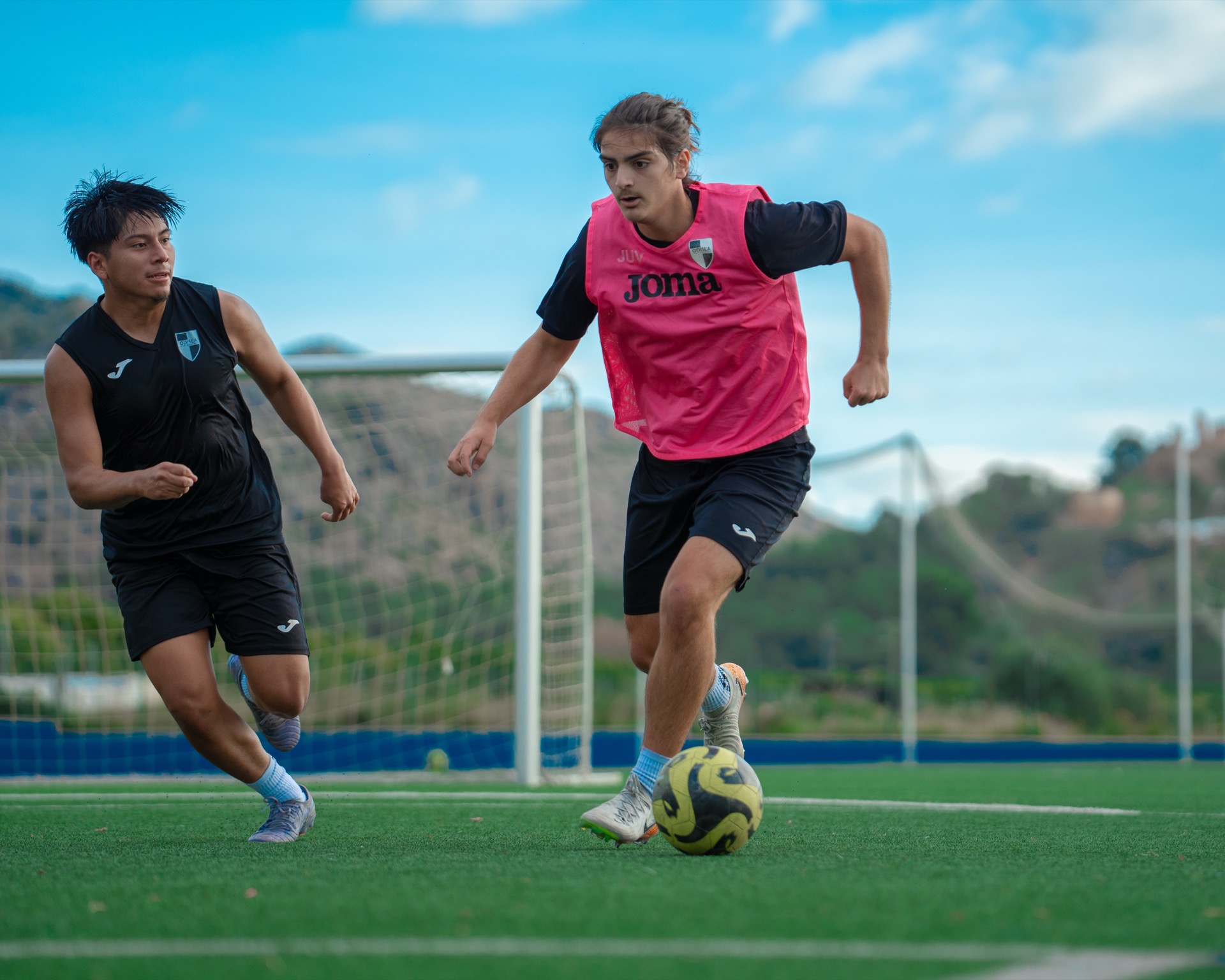 Two academy players contesting the ball in training